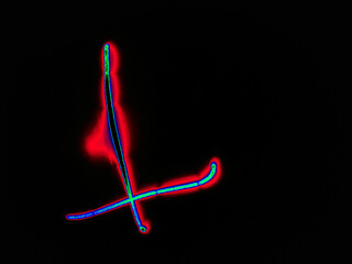 Glowing English letter L. On a black background with colored neon lines, a letter of the English alphabet is written by hand. The letter glows pink-red, creating a green-blue halo around it.