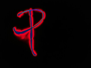 Glowing English letter P. On a black background with colored neon lines, a letter of the English alphabet is written by hand. The letter glows pink-red, creating a green-blue halo around it.