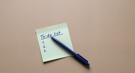 A to-do list with a pen on a pastel background