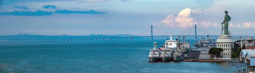 Naklejka premium Surabaya's Tanjung Perak harbor and cruise terminal with the bridge connecting with madura island in the background,, East Java, Indonesia