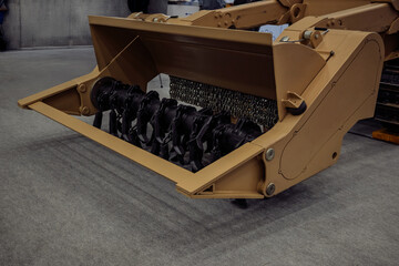 Military demining equipment with flail system for landmine clearance operations. Heavy machinery attachment with rotating chains for explosive ordnance disposal.