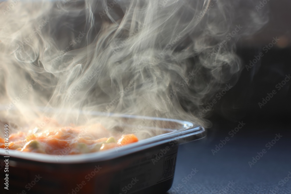 Leinwandbilder steam billowing from heated frozen dinner in a tray viewed from above with open right margin
