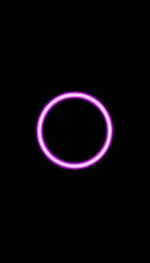 Neon purple circle frame on a dark black rectangular background, with space for copy.,