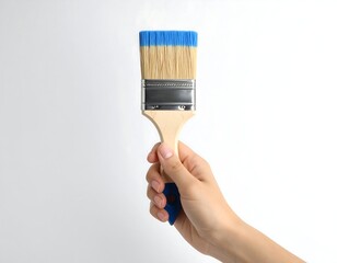 Hand holding paintbrush preparing to paint