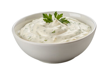 A bowl of creamy white sauce with green herbs and a parsley garnish on a black background isolated