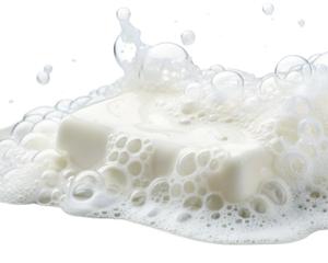 A close up of a white bar of soap surrounded by a large amount of white bubbles and foam on black