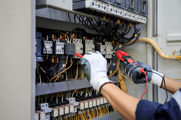 Electrician use meters to measure current at devices in the MDB cabinet, for safety in the electrical system.