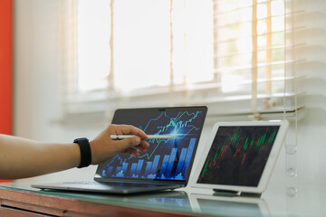 Financial expert studying market data and forecasts on screens — capturing themes of investment,...