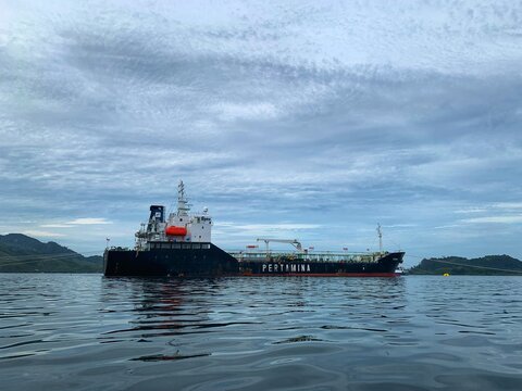 a pertamina oil tanker floating in the ocean with an island in the background. Indonesia - Sibolga May 28, 2025