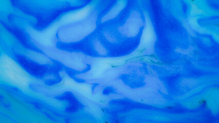 Obraz premium High-resolution abstract background featuring rich deep blue ink swirling in milky liquid, resembling ocean waves or a starry night sky. Perfect for digital design