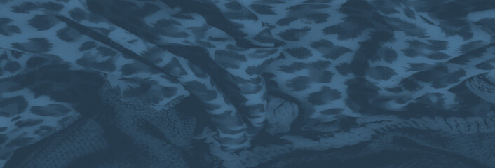 Blurred intricate leopard print textile with layered braids and tassels, showcasing a striking combination of bold patterns and sophisticated texture contrasts.