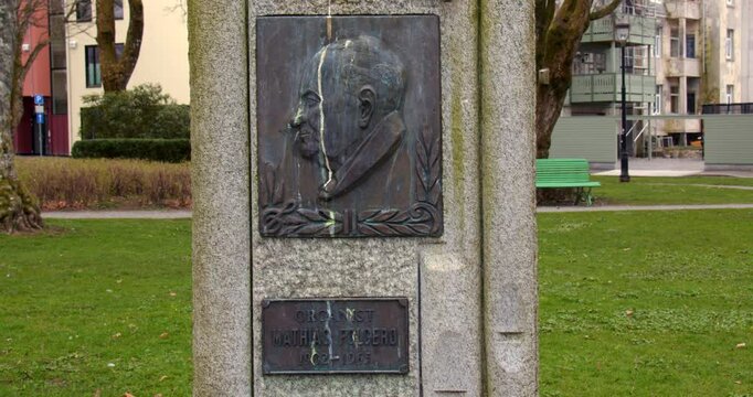 wide shot of a metal plaque in stone of Organist Mathias Folgero, Byparken, Haugesund
