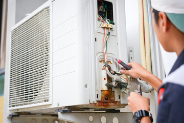 Repairman fix air conditioning systems, Male technician service for repair and maintenance of air conditioners