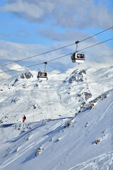 Vintage ski lifts in Courchevel ski resort by winter, French alps.