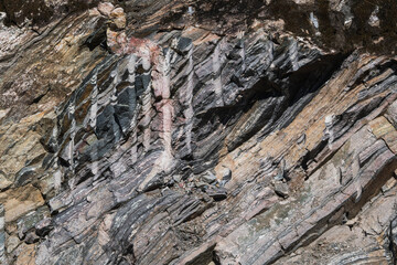 Texture of an ancient Norwegian rock: detailed layers, folds, and natural stone patterns. An...
