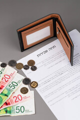 Rental or Residential Lease agreement contract in Hebrew and piggy bank. Short and long term rentals in Israel, housing searching crisis, signing lease agreement, and rising prices.