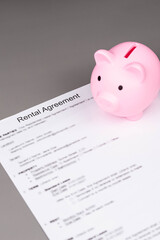 Rental or Residential Lease agreement contract and piggy bank. Short and long term rentals, housing searching crisis, signing lease agreement, and rising prices.