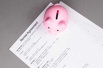 Rental or Residential Lease agreement contract and piggy bank. Short and long term rentals, housing searching crisis, signing lease agreement, and rising prices.