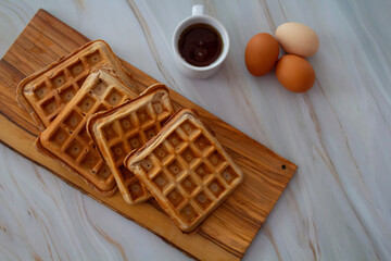 Freshly made waffles served with seasonal fruits and syrup &ndash; delicious homemade breakfast