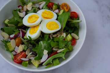 Fresh and vibrant homemade salad topped with sliced eggs and a light vinaigrette