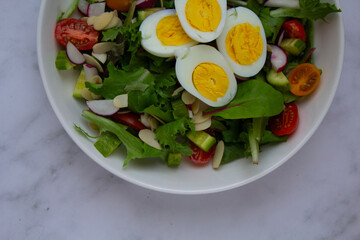 Fresh and vibrant homemade salad topped with sliced eggs and a light vinaigrette