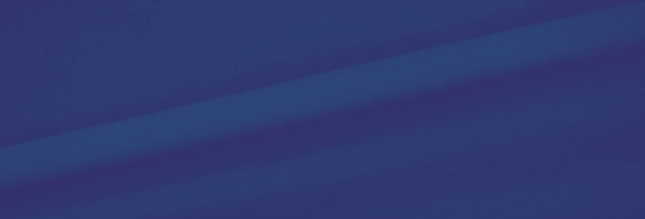 Blurred smooth blue fabric with soft folds and fine details, creating a calming and elegant visual...