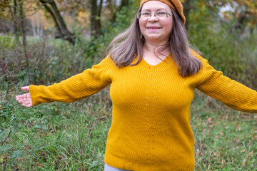 Happy middle-aged woman in mustard sweater and beret, enjoying autumn, smiling, joyful expression,...