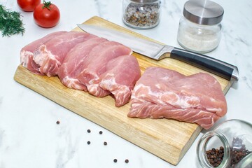Pieces of pork on a wooden board