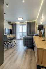 Stylish Living Room with Dining Area and Balcony View
