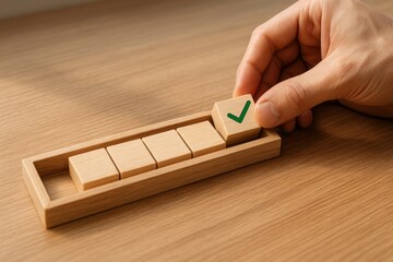 hand placing the final wooden block with a green checkmark into a progress bar made of natural wood pieces