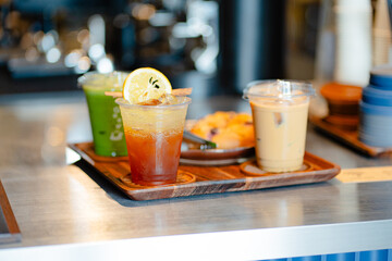 Glass of ice coffee and ice matcha green tea on wooden tray of a coffee shop summer terrace, menu photography.