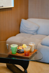 Glass of ice coffee and ice matcha green tea on wooden tray of a coffee shop summer terrace, menu photography.
