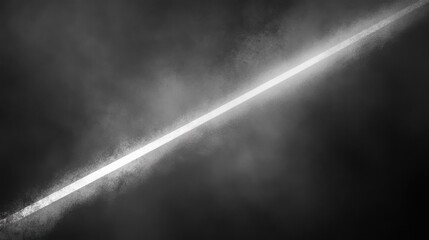 Bright white light beam cutting through dark smoke in diagonal line on black background with strong contrast