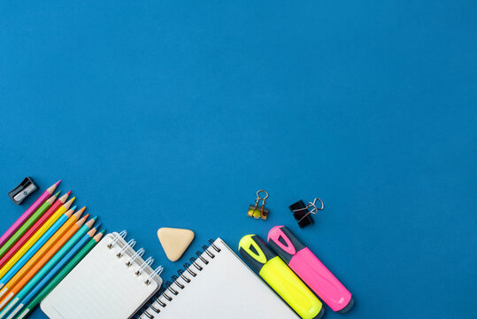 Bright school supplies on a blue background. The back to school concept
