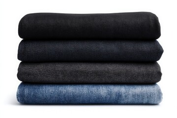 Four distinct pieces of denim fabric are stacked on top of each other, showcasing different shades of blue and black.