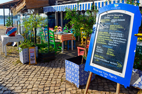 Alvor, Algarve, Faro district, Portugal, Europe : Menu in front of restaurant at the seaside near the beach, Atlantic Ocean