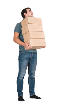 Full length portrait of contented young man carrying carton boxes looks away imagining moving to a house in a big modern city, isolated on transparent background