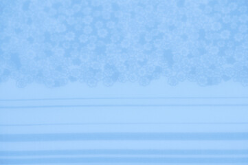 A pale blue foundation with a faint floral cluster drifting across the upper portion, infusing the...