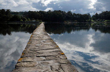 Narrow stone path in Salinas do Ulló, in Vilaboa, Galicia, Spain