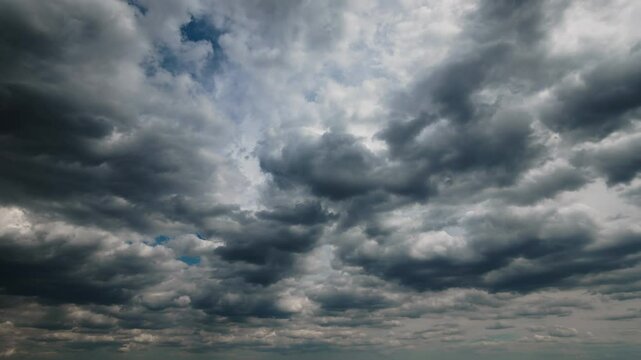 dark dramatic sky with black stormy clouds before rain as abstract background, extreme weather timelapse
