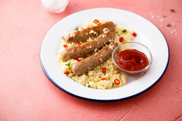 Grilled sausages with couscous and tomato sauce	