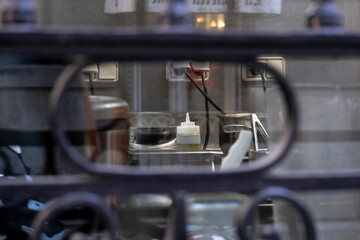 Detail of an oil can in an industrial kitchen with the rest of the elements blurred, Spanish virgin olive oil.
