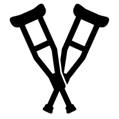 A pair of black crutches are crossed against a white background