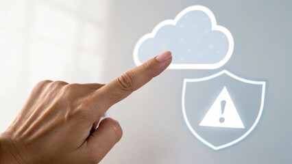 A hand interacting with a cloud icon and a warning shield, symbolizing digital security.