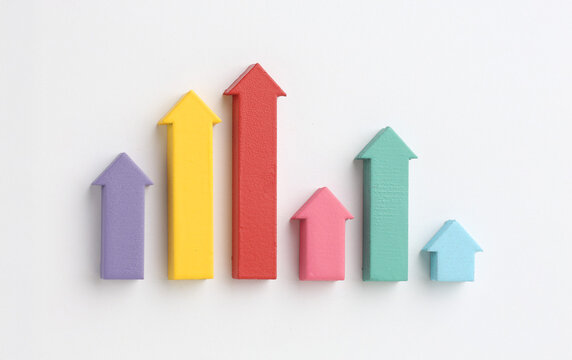 Multicoloured arrows pointing up and down. Symbolise growth progress, success in business finance. Rising bars of graphs represent market trends, return 