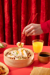 White fish steamed in traditional Chinese and Japanese style with rice on red background. Modern still life