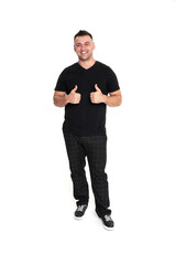 A handsome dark-haired man in a black T-shirt, trousers and sneakers on a white background