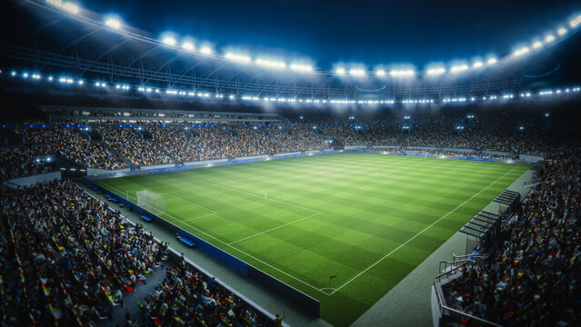 Night View of a Massive Soccer Stadium Filled With Spectators. Arena Surrounds a Green Pitch With Visible Goals. Thousands of Fans on a Major Sport Event. Wide Shot