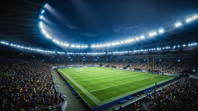 Night Aerial View of a Packed American Football Stadium With Thousands of Fans. the Footage Captures the Scale of a Major Sport Event