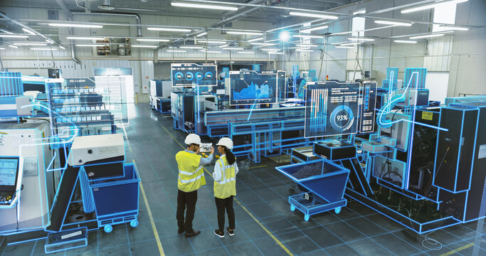 Two Engineers in Safety Vests Use a Tablet to Interact With Holographic Data in a High-tech Factory, Activate AI Facility Analysis, Advanced Machinery, Digital Interfaces, Futuristic Manufacturing